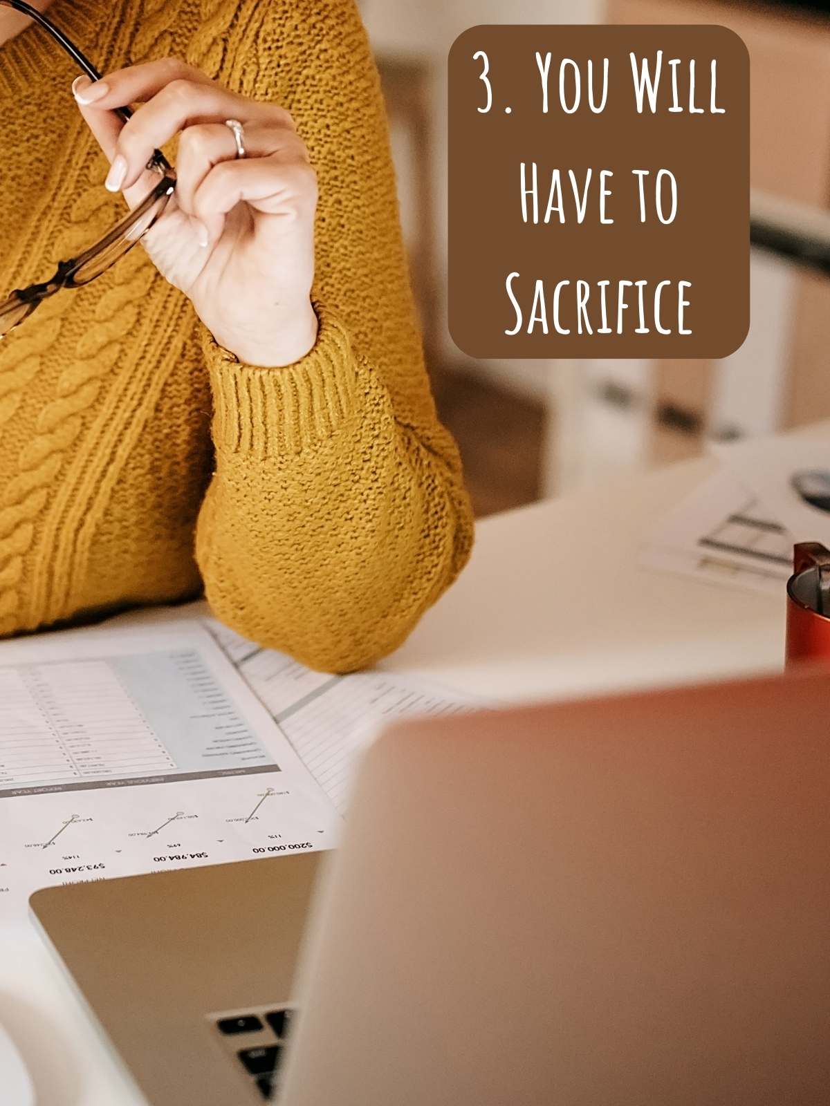 You will have to sacrifice. Photo of laptop on woman's desk.