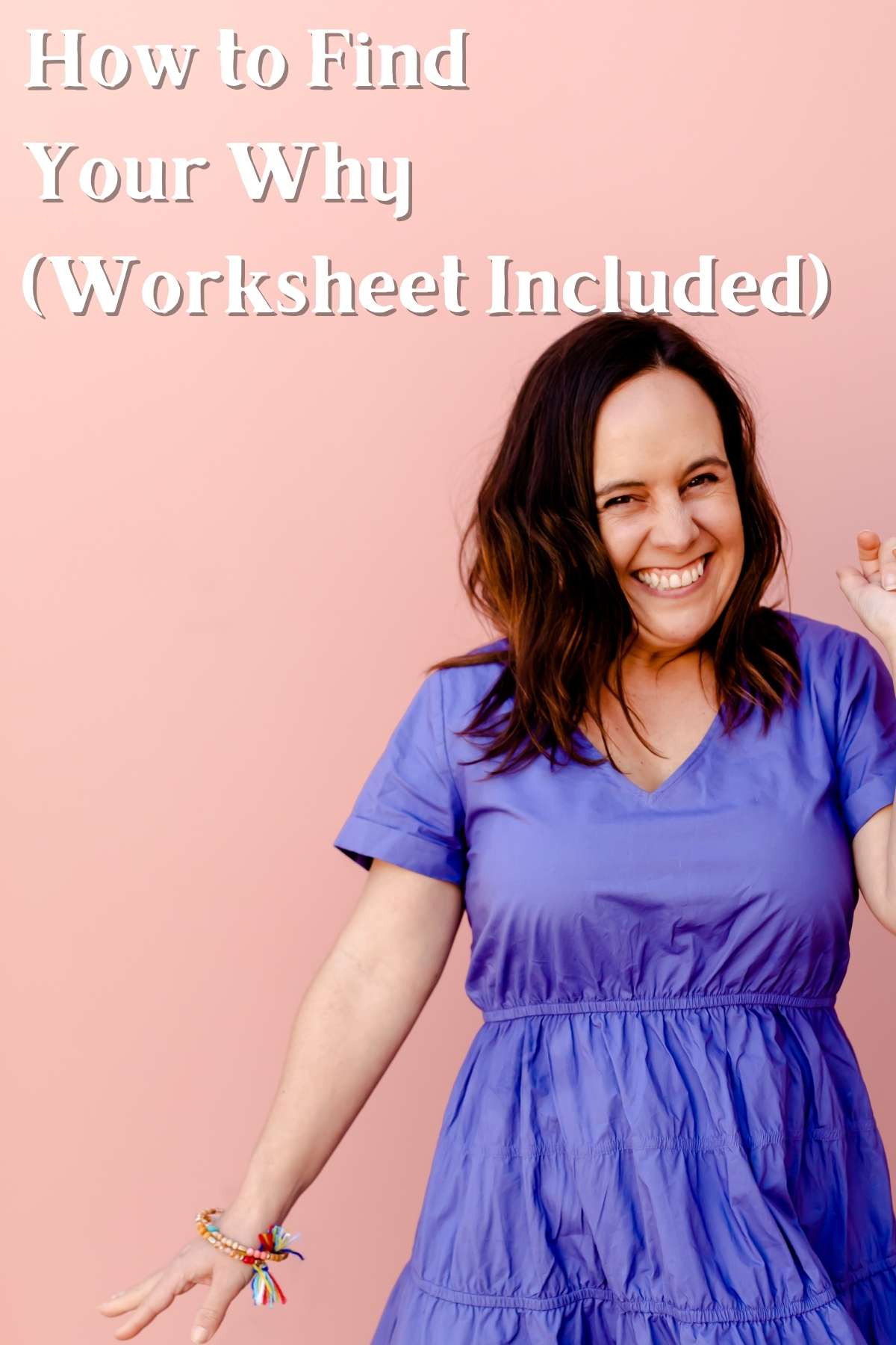 How to find your why worksheet. Photo of woman smiling in front of pink wall.